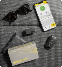 Connected car smartphone app beside a car key and branded card
