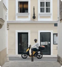 Rider on a shared e-moped in a city street